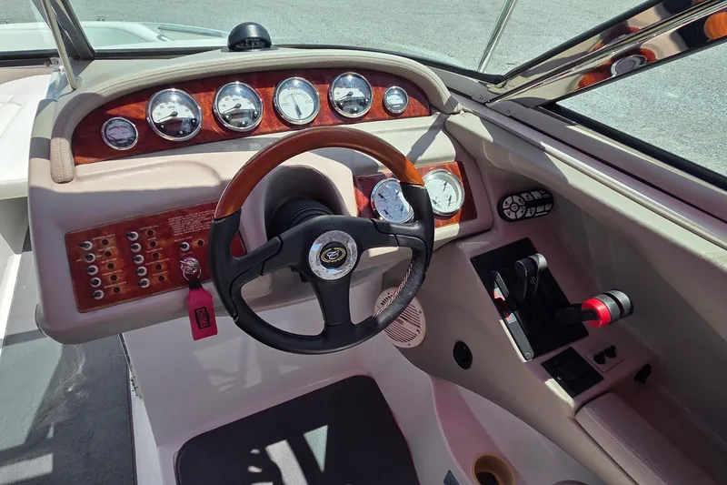 Slide: The Image of 2003 Cobalt 282 boat dashboard with gauges, steering wheel, and control panel. - 8