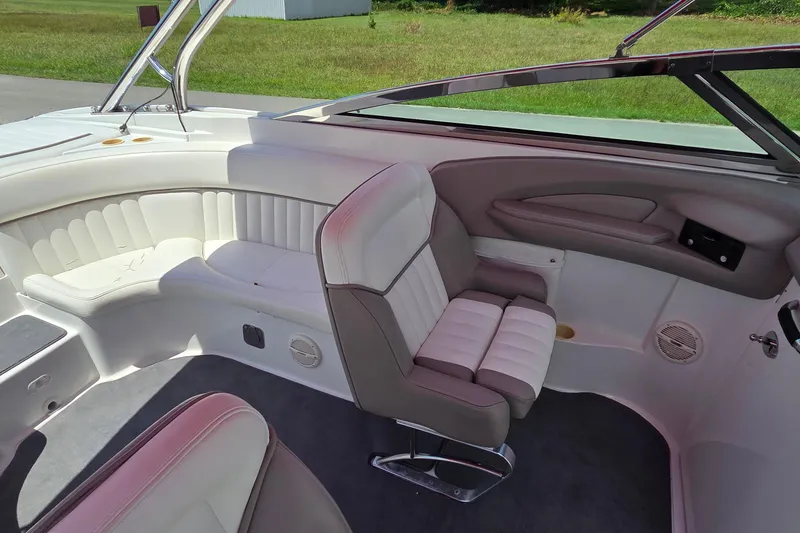 Slide: The Image of Interior of a 2003 Cobalt 282 boat with white and gray seating. - 9