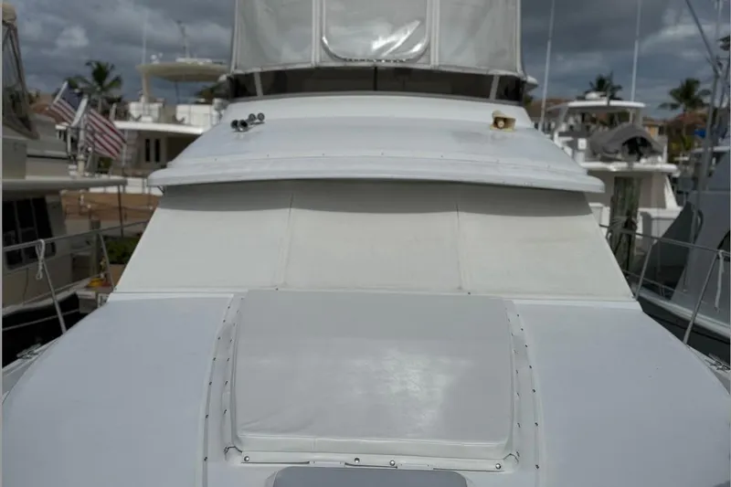 Slide: The Image of 1998 Carver 440 Aft Cabin Motor Yacht docked, featuring sleek white exterior and covered deck. - 3