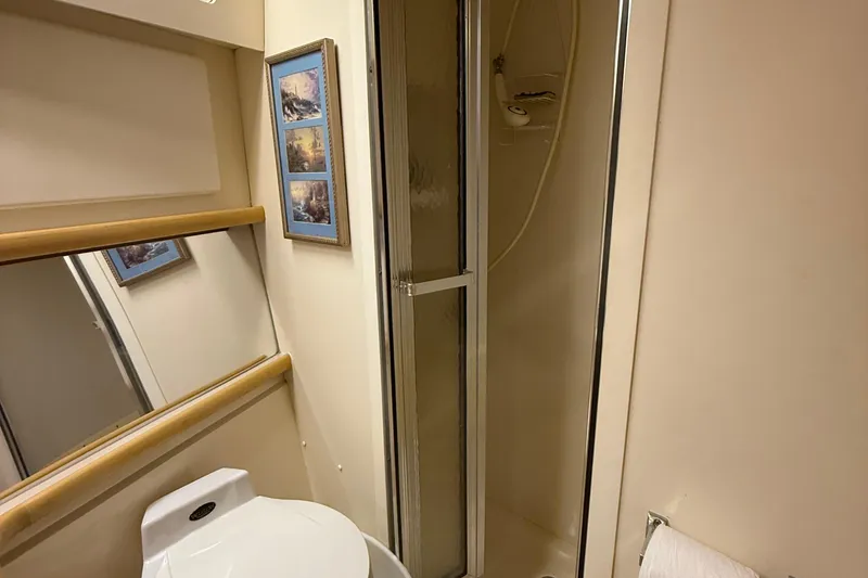 Slide: The Image of Bathroom interior of 1998 Carver 440 Aft Cabin Motor Yacht with shower and framed art. - 8
