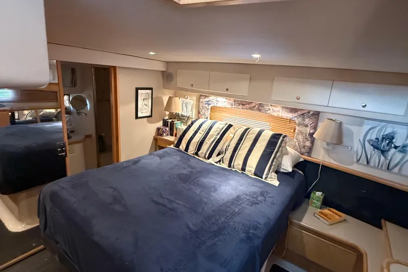Slide: The Image of Luxurious bedroom in 1998 Carver 440 Aft Cabin Motor Yacht with cozy bedding. - 10
