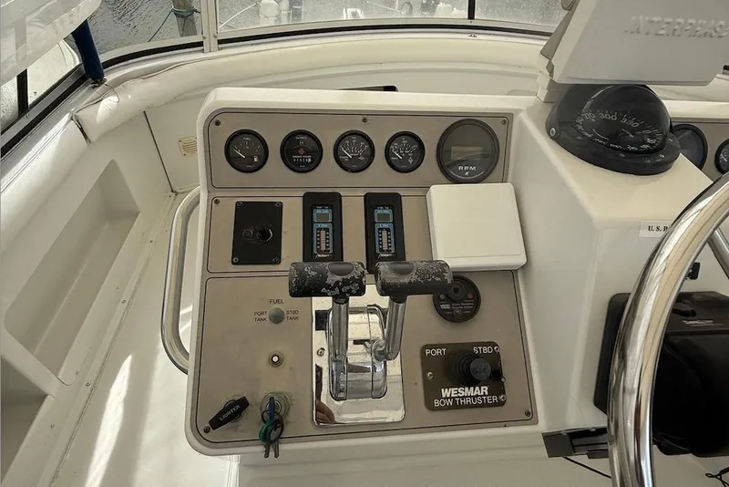 Slide: The Image of Control panel of a 1998 Carver 440 Aft Cabin Motor Yacht with gauges and throttle. - 4