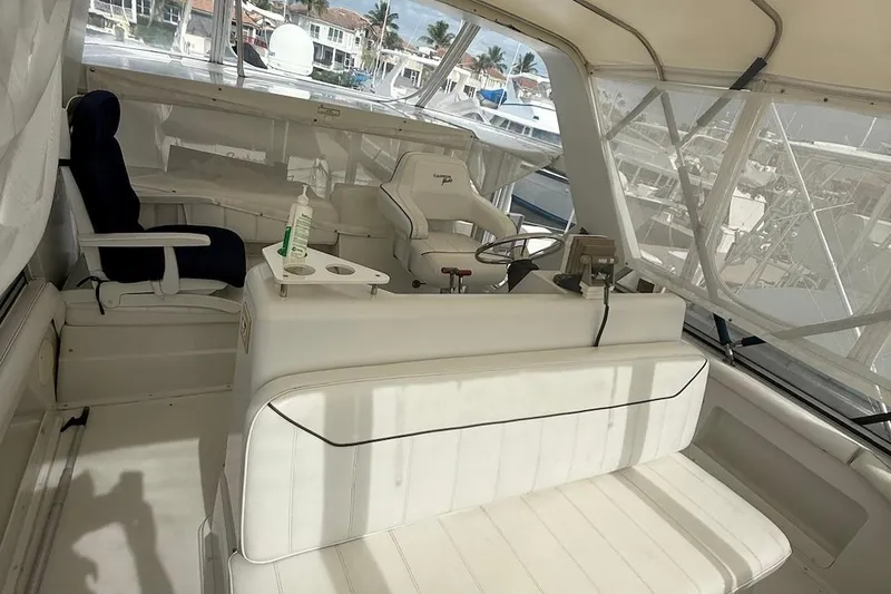 Slide: The Image of 1998 Carver 440 Aft Cabin Motor Yacht interior with white seating and steering area. - 5