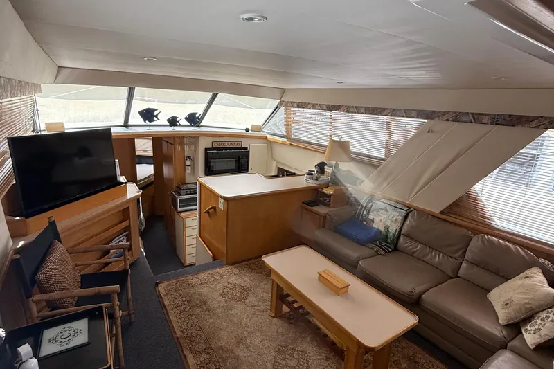 Slide: The Image of Interior of 1998 Carver 440 Aft Cabin Motor Yacht with cozy seating and modern amenities. - 9