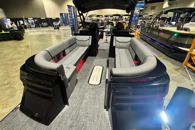 Slide: The Image of 2026 Veranda Vertex VX285DCRC Premium pontoon boat interior with luxurious seating at a boat show. - 10