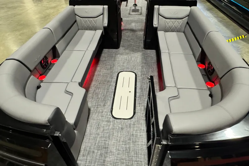 Slide: The Image of 2026 Veranda Vertex VX285DCRC Premium boat interior with gray seating and red cup holders. - 11
