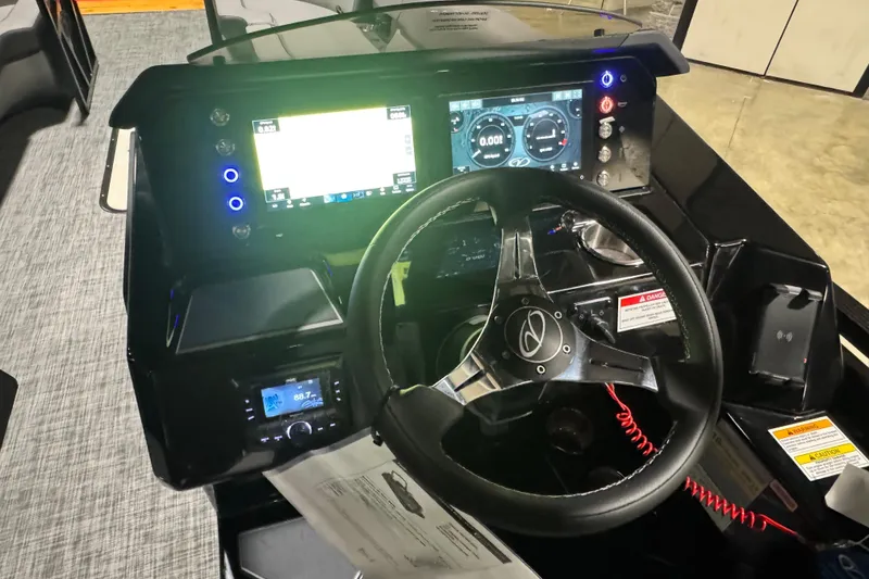 Slide: The Image of 2026 Veranda Vertex VX285DCRC Premium boat dashboard with steering wheel and digital displays. - 13