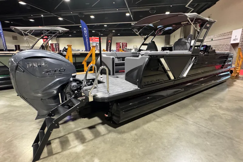 Slide: The Image of 2026 Veranda Vertex VX285DCRC Premium pontoon boat with Yamaha engine displayed indoors. - 4