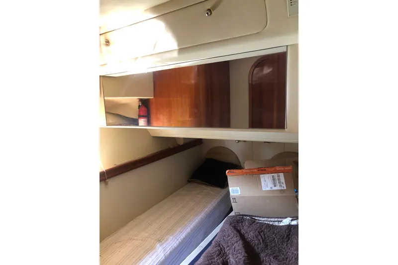 Slide: The Image of Interior cabin of 2002 Birchwood Challenger 460 Flybridge with bed and storage. - 101