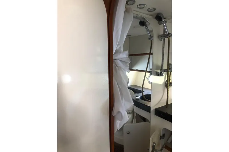 Slide: The Image of Interior of 2002 Birchwood Challenger 460 Flybridge yacht bathroom with shower and sink. - 102