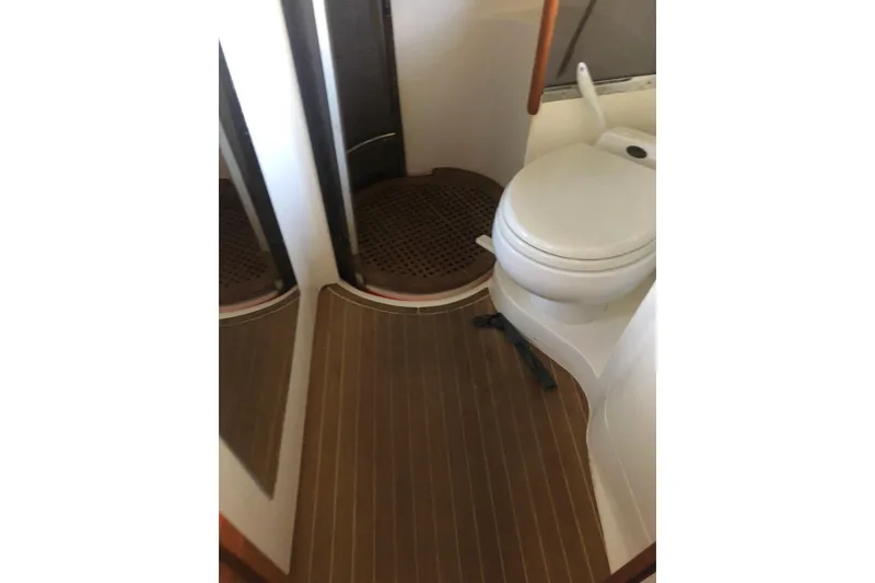 Slide: The Image of Birchwood Challenger 460 Flybridge 2002 yacht bathroom with wooden flooring and compact toilet. - 108