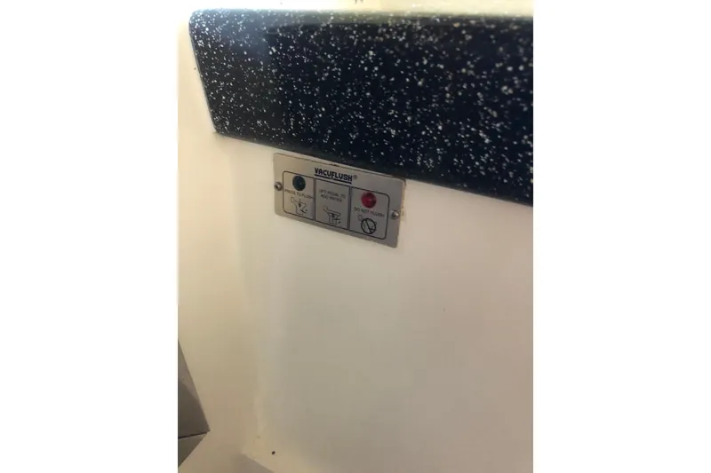 Slide: The Image of Control panel on 2002 Birchwood Challenger 460 Flybridge, featuring VacuFlush system. - 109