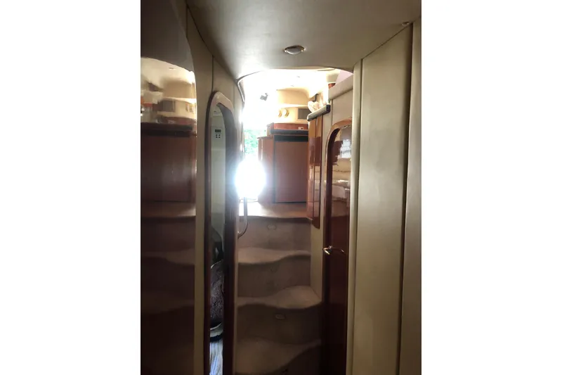 Slide: The Image of Interior view of 2002 Birchwood Challenger 460 Flybridge yacht with staircase and wooden finishes. - 115