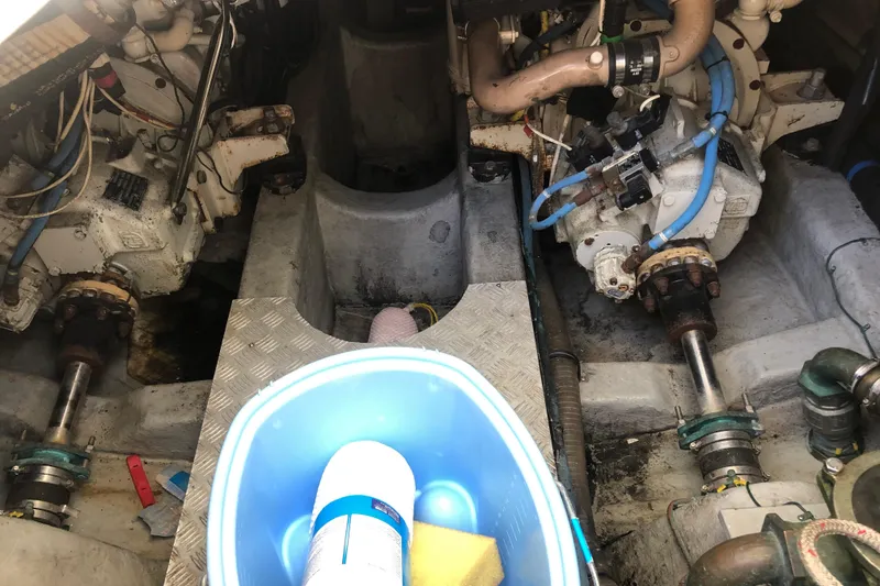 Slide: The Image of Engine room of 2002 Birchwood Challenger 460 Flybridge with cleaning supplies in foreground. - 12