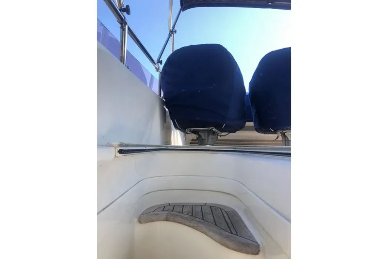 Slide: The Image of Flybridge seating on 2002 Birchwood Challenger 460 yacht, featuring blue covers and wooden flooring. - 18