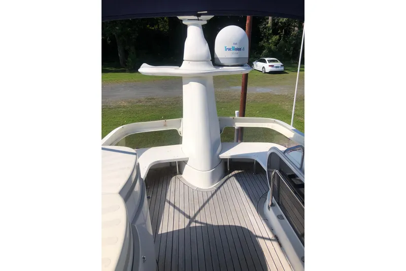 Slide: The Image of 2002 Birchwood Challenger 460 Flybridge deck with satellite equipment and outdoor seating. - 19