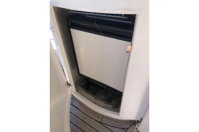 Slide: The Image of Refrigerator on 2002 Birchwood Challenger 460 Flybridge yacht, open door, wooden deck visible. - 22