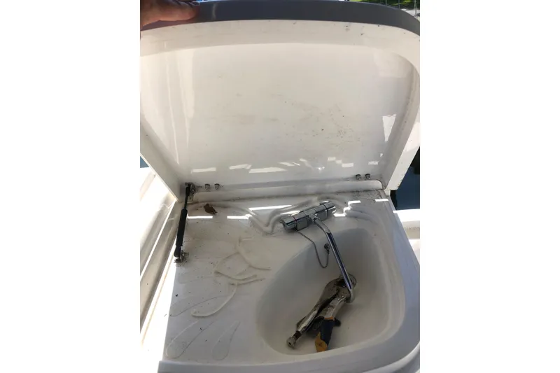 Slide: The Image of Open sink compartment on 2002 Birchwood Challenger 460 Flybridge yacht, showing faucet and tools. - 27