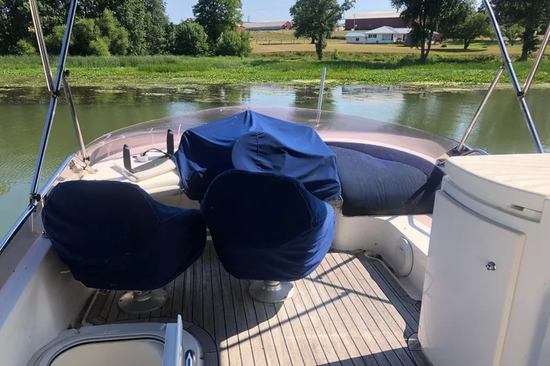 Slide: The Image of 2002 Birchwood Challenger 460 Flybridge with covered seating on a serene river. - 30