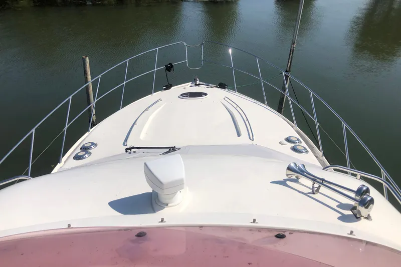 Slide: The Image of Bow view of 2002 Birchwood Challenger 460 Flybridge yacht on calm water. - 31