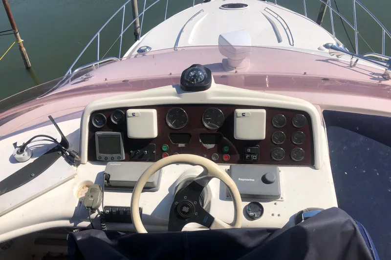 Slide: The Image of Flybridge helm of 2002 Birchwood Challenger 460 with steering wheel and navigation instruments. - 32