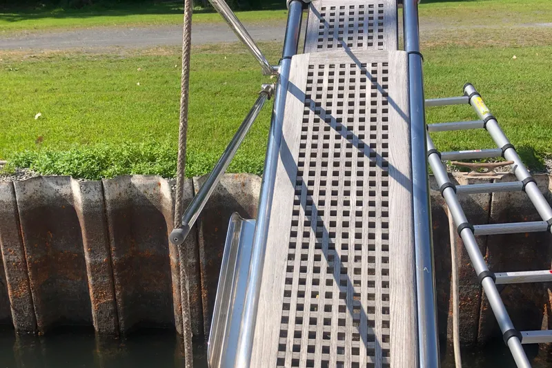 Slide: The Image of Gangway and ladder on Birchwood 460 FB yacht, 2003 model, near grassy shore. - 4
