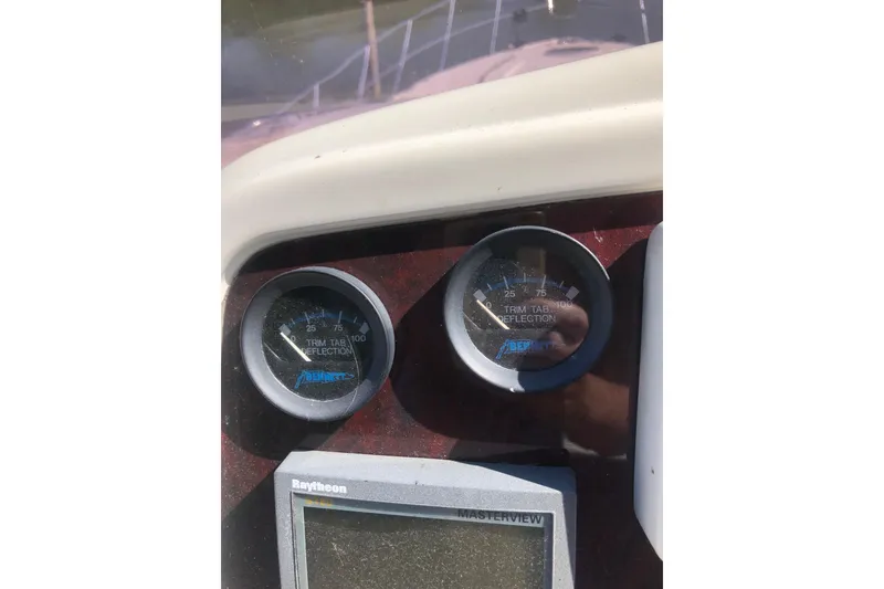 Slide: The Image of Close-up of 2002 Birchwood Challenger 460 Flybridge dashboard gauges and Raytheon display. - 41