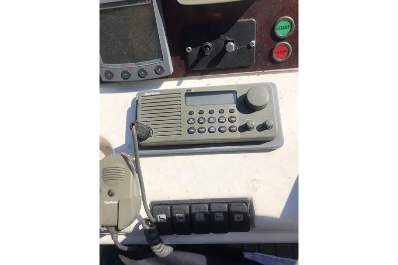 Slide: The Image of Control panel of a 2002 Birchwood Challenger 460 Flybridge with radio and switches. - 42