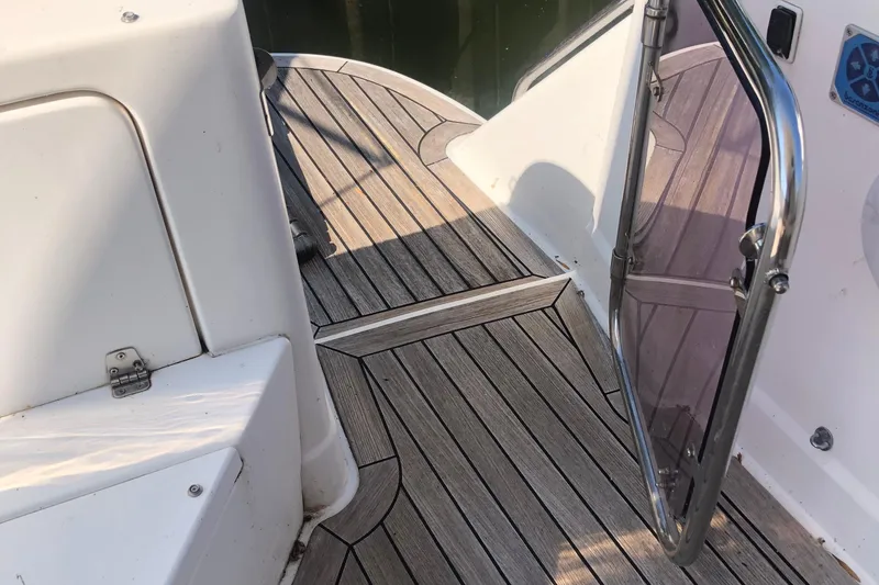 Slide: The Image of Birchwood 460 FB 2003 boat deck with wooden flooring and open glass door. - 5