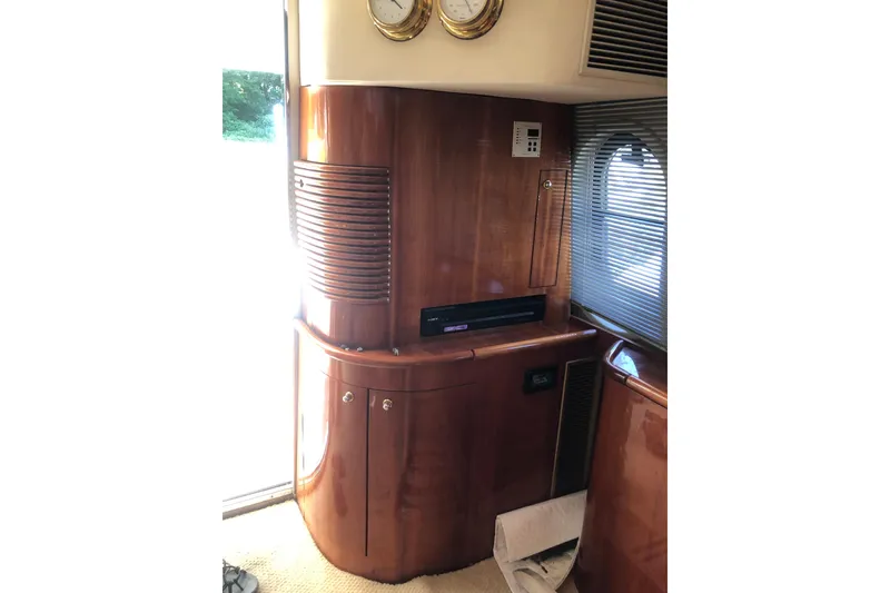 Slide: The Image of Interior of 2002 Birchwood Challenger 460 Flybridge with wooden cabinetry and nautical instruments. - 56