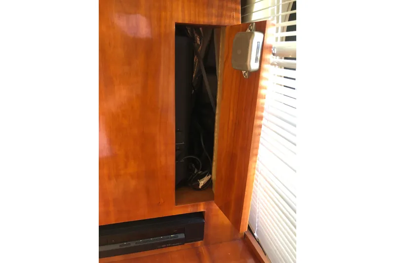 Slide: The Image of Wooden interior panel with open compartment on Birchwood Challenger 460 Flybridge, 2002 model. - 61