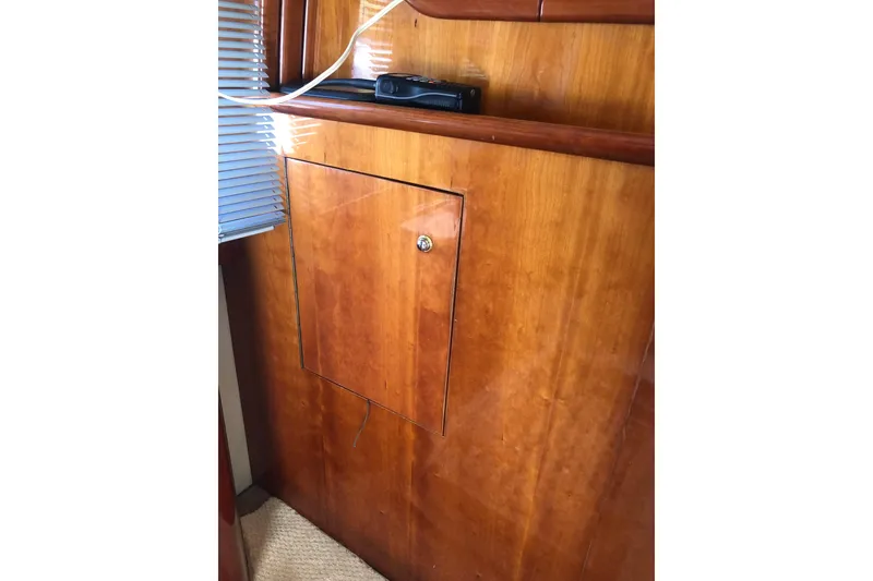 Slide: The Image of Wooden interior of 2002 Birchwood Challenger 460 Flybridge yacht with cabinet and blinds. - 62