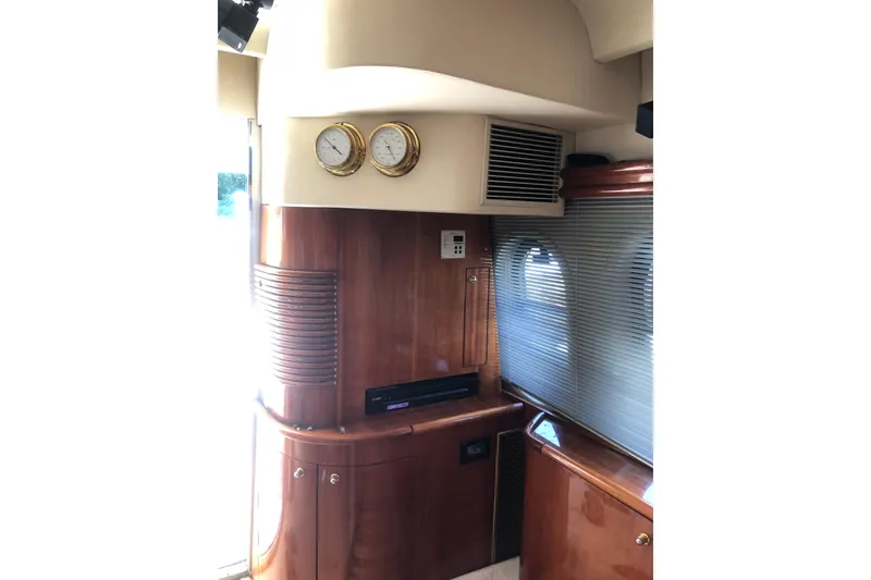 Slide: The Image of Interior of 2002 Birchwood Challenger 460 Flybridge with wood paneling and nautical instruments. - 65