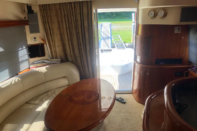 Slide: The Image of Interior of 2002 Birchwood Challenger 460 Flybridge yacht with elegant seating and wooden accents. - 66