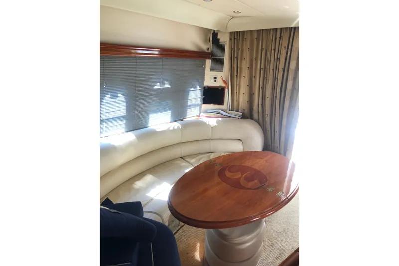 Slide: The Image of Luxurious interior of 2002 Birchwood Challenger 460 Flybridge yacht with elegant seating and wooden table. - 67