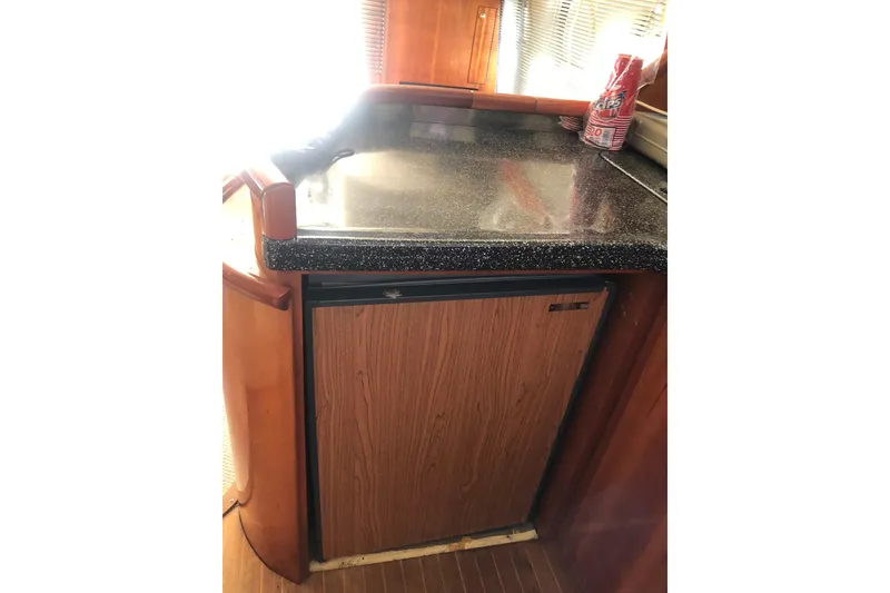 Slide: The Image of Birchwood Challenger 460 Flybridge 2002 yacht interior with wooden cabinetry and countertop. - 74