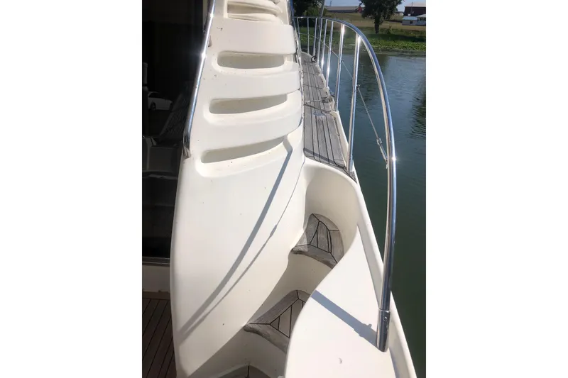 Slide: The Image of Side view of 2002 Birchwood Challenger 460 Flybridge yacht with sleek design and railing. - 8