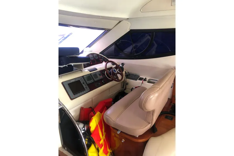 Slide: The Image of 2002 Birchwood Challenger 460 Flybridge interior with navigation controls and leather seating. - 81