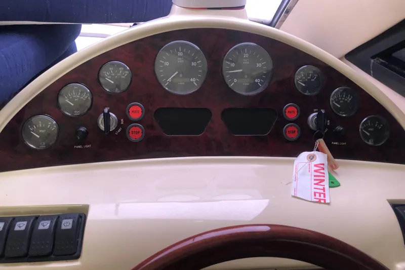 Slide: The Image of Dashboard of a 2002 Birchwood Challenger 460 Flybridge with gauges and controls. - 89