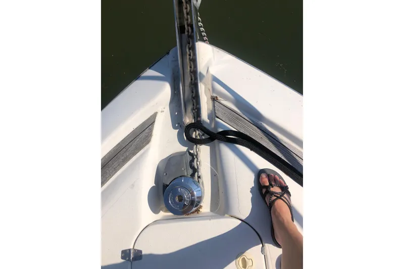 Slide: The Image of Bow of 2002 Birchwood Challenger 460 Flybridge with anchor chain and foot in sandals. - 9