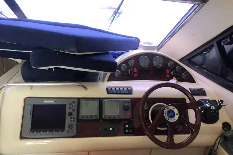 Slide: The Image of 2002 Birchwood Challenger 460 Flybridge helm with navigation instruments and wooden steering wheel. - 91