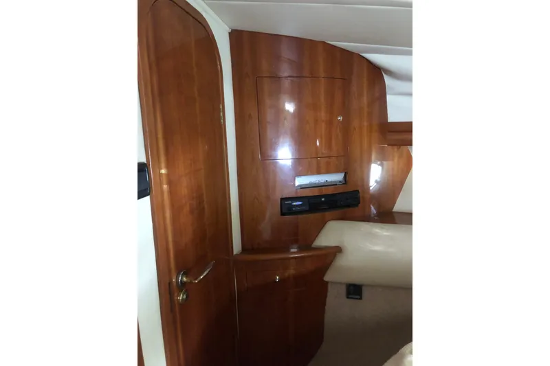 Slide: The Image of Interior of 2002 Birchwood Challenger 460 Flybridge with polished wood paneling and door. - 94