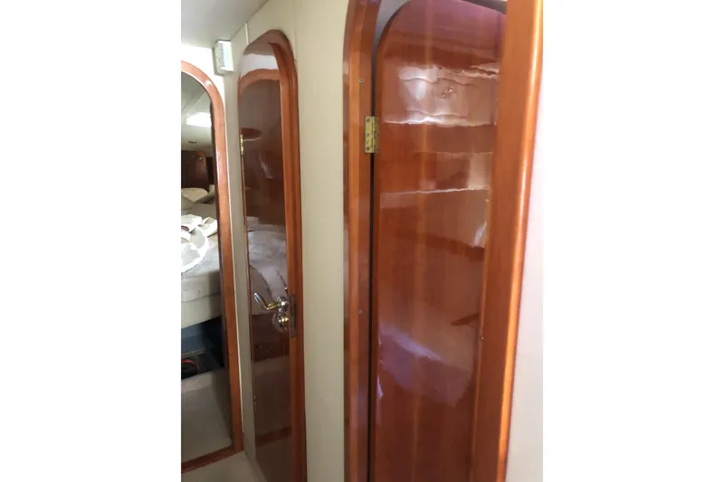 Slide: The Image of Interior of 2002 Birchwood Challenger 460 Flybridge, featuring wooden doors and cozy cabin space. - 99