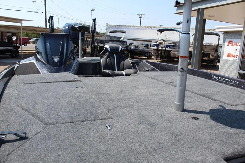 Slide: The Image of 2026 Skeeter ZXE20 boat with spacious deck and modern seating at a dealership. - 18