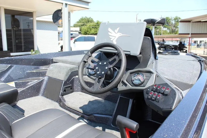 Slide: The Image of 2026 Skeeter ZXE20 boat interior with steering wheel and control panel. - 19
