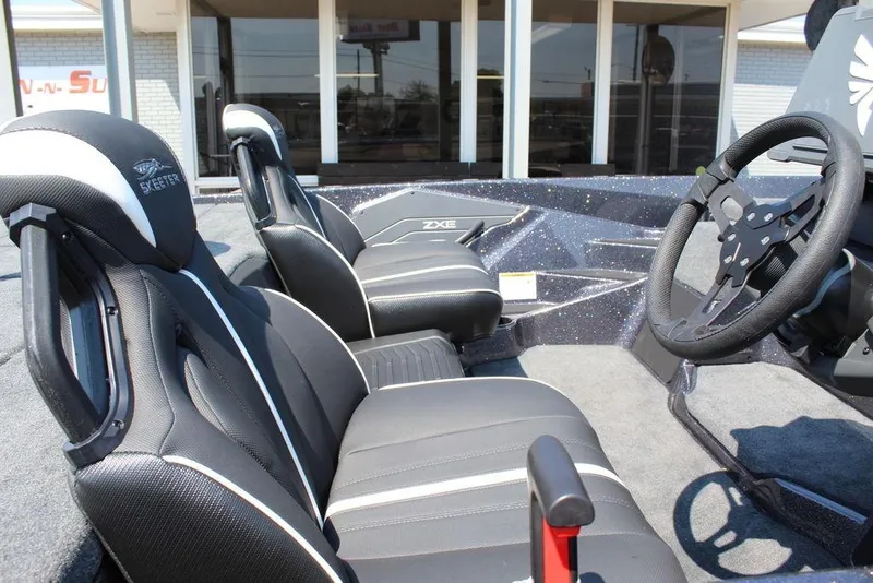Slide: The Image of 2026 Skeeter ZXE20 boat interior with black seats and steering wheel. - 22