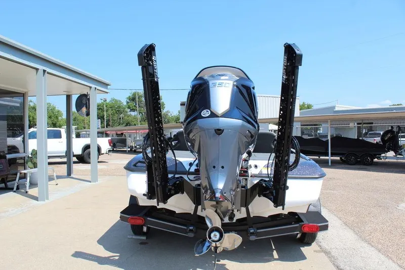 Slide: The Image of 2026 Skeeter ZXE20 boat with powerful outboard motor, parked outdoors on a sunny day. - 4