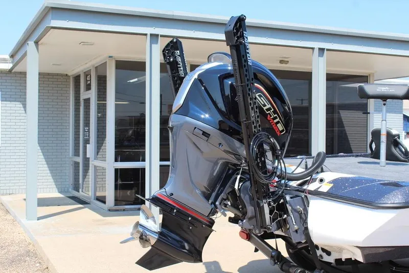 Slide: The Image of 2026 Skeeter ZXE20 boat with powerful outboard motor, parked outside a modern building. - 5
