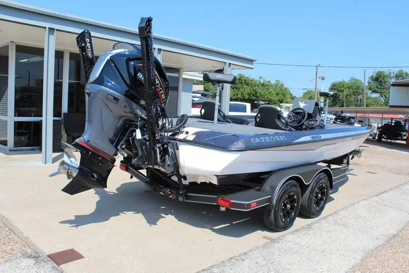 Slide: The Image of 2026 Skeeter ZXE20 boat on trailer, parked outside a building. - 6