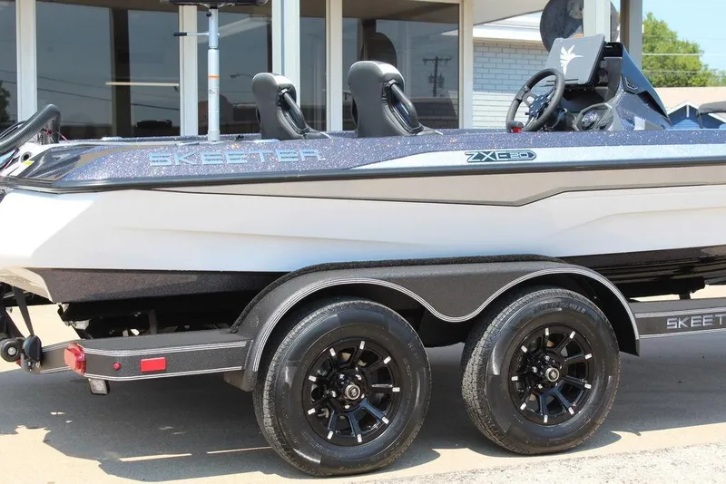 Slide: The Image of 2026 Skeeter ZXE20 boat on trailer, showcasing sleek design and modern features. - 8